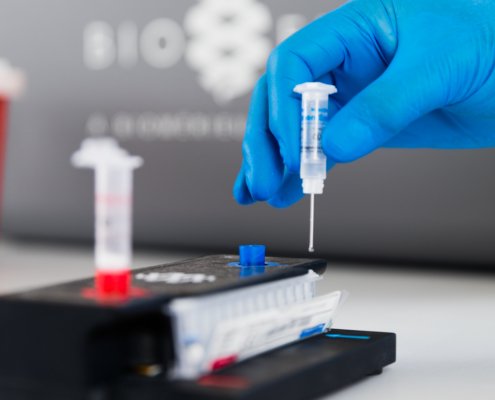 Sample medium being loaded into a syndromic testing pouch.