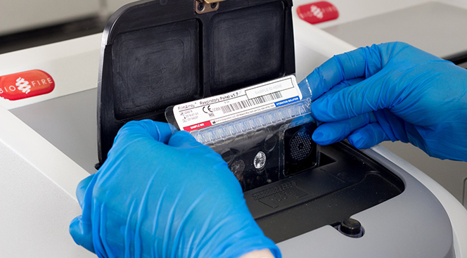 Respiratory Pouch Lab technician loading a respiratory panel into the BioFire® System.
